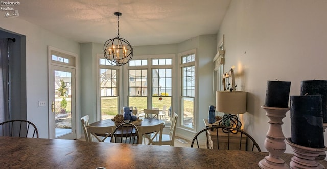 dining space with an inviting chandelier