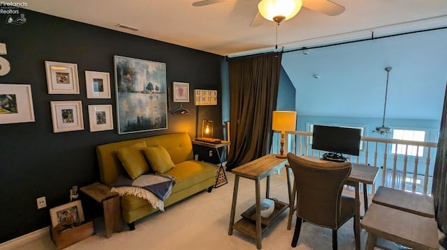 sitting room featuring visible vents, carpet floors, and a ceiling fan