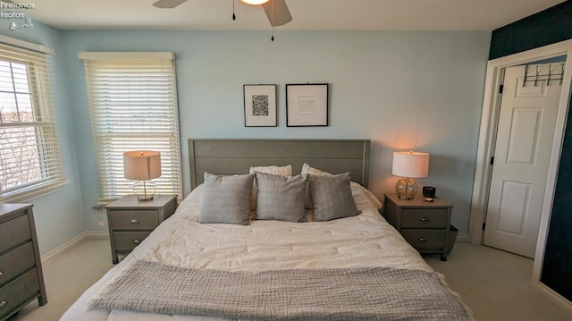 bedroom with baseboards, a ceiling fan, and light colored carpet