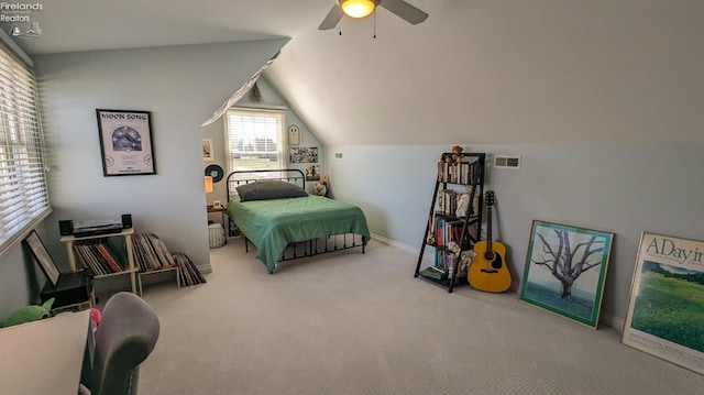 bedroom featuring carpet floors, a fireplace, lofted ceiling, visible vents, and ceiling fan