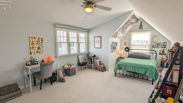 carpeted bedroom with vaulted ceiling, ceiling fan, and a textured ceiling