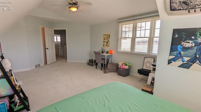 bedroom featuring light carpet, baseboards, visible vents, and vaulted ceiling