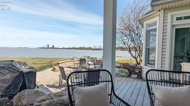 view of patio with outdoor dining space and a water view