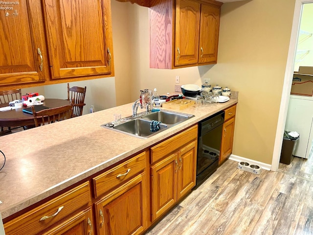 kitchen with light wood-style flooring, a sink, light countertops, brown cabinets, and dishwasher