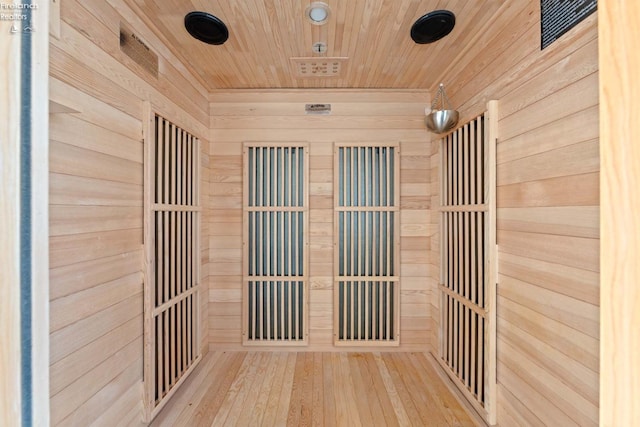 interior space with wood ceiling, wooden walls, and wood finished floors