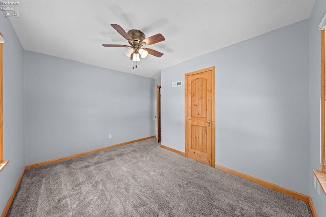 unfurnished bedroom with a ceiling fan, baseboards, visible vents, and carpet flooring