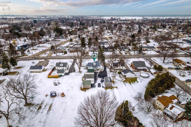 snowy aerial view with a residential view