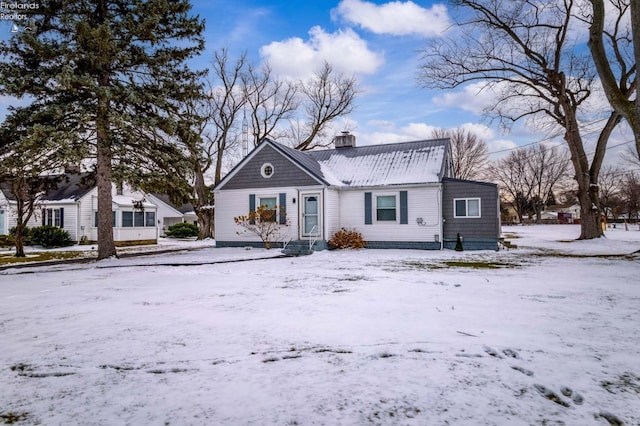 view of front of home featuring metal roof and a chimney