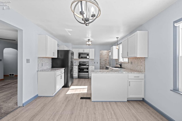 kitchen featuring white cabinets, stainless steel appliances, and a sink