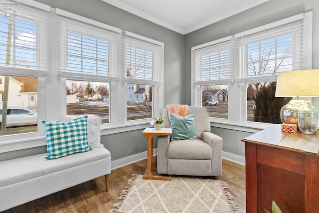 sitting room featuring crown molding, baseboards, and wood finished floors