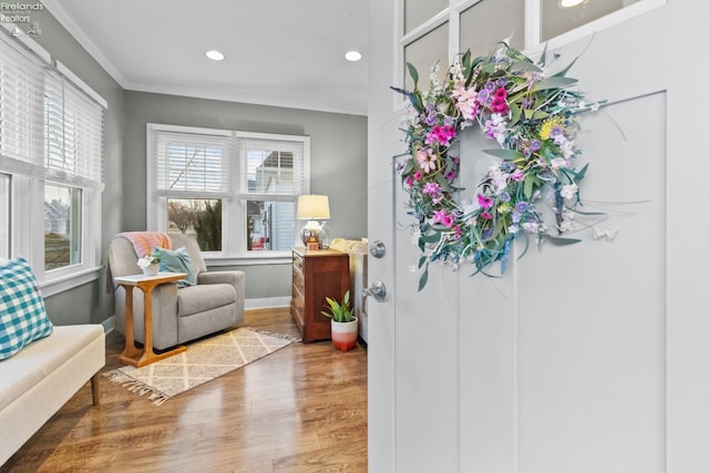 sitting room featuring ornamental molding, recessed lighting, baseboards, and wood finished floors