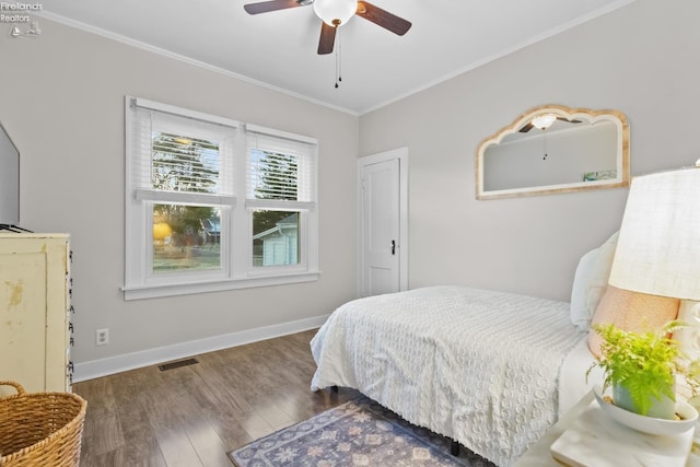 bedroom with baseboards, visible vents, ceiling fan, ornamental molding, and wood finished floors