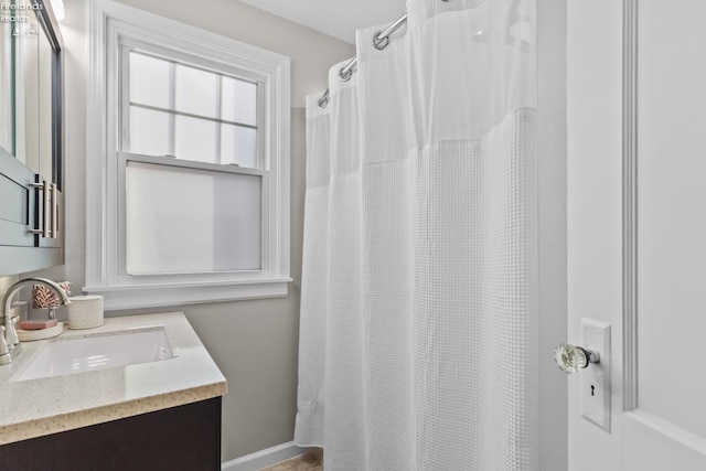 bathroom with a shower with shower curtain and vanity