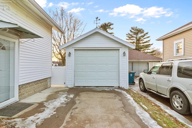 detached garage featuring fence