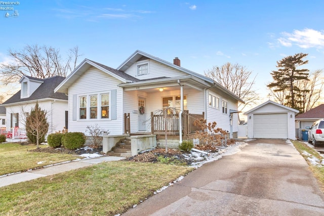 bungalow-style house with a chimney, a porch, concrete driveway, a garage, and an outdoor structure