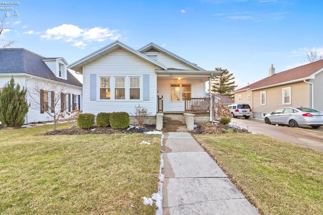 bungalow-style house with a porch and a front lawn