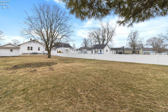 view of yard with a residential view and fence