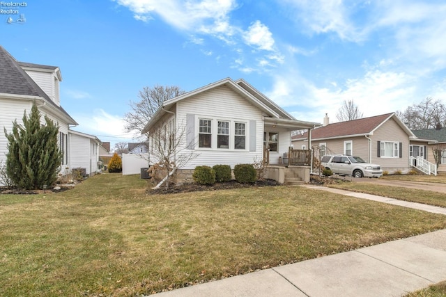 bungalow-style home featuring covered porch and a front yard