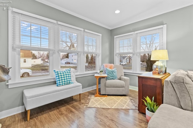 living area featuring ornamental molding, recessed lighting, wood finished floors, and baseboards