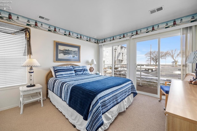 bedroom with light carpet, multiple windows, and visible vents