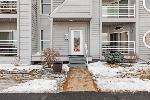 view of snow covered property entrance