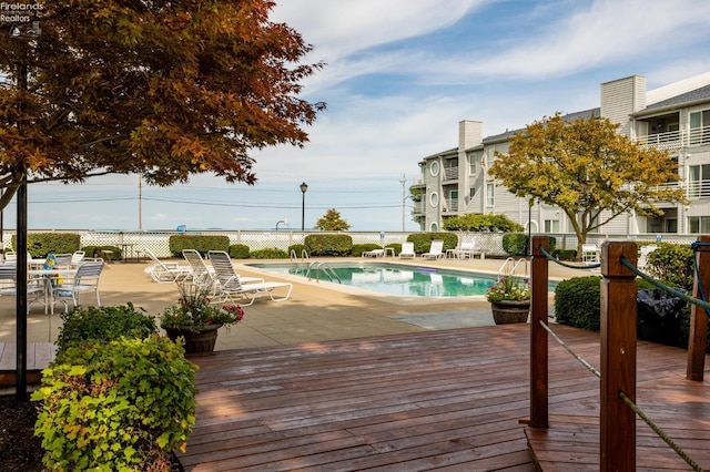 pool with a deck and fence