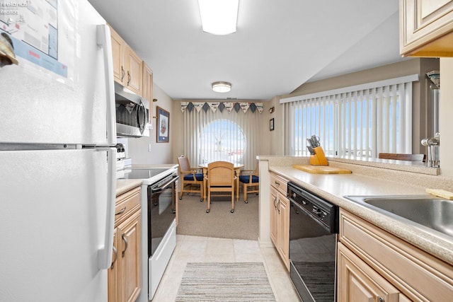 kitchen with white appliances, light countertops, and light brown cabinetry