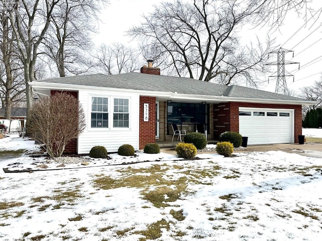 ranch-style house featuring a garage, driveway, brick siding, and a chimney