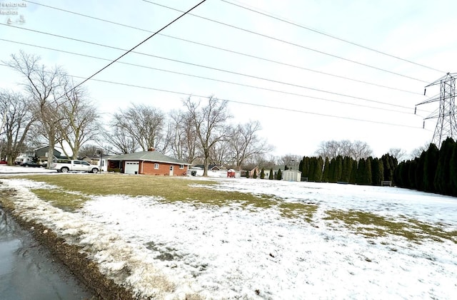 view of yard layered in snow