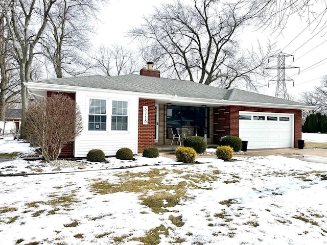 ranch-style house featuring driveway, brick siding, a chimney, and an attached garage