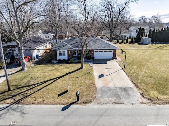 ranch-style home with a garage, brick siding, concrete driveway, and a front yard