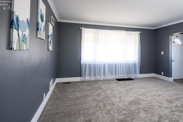 unfurnished room featuring ornamental molding, arched walkways, baseboards, and carpet