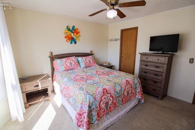 bedroom with light carpet and ceiling fan