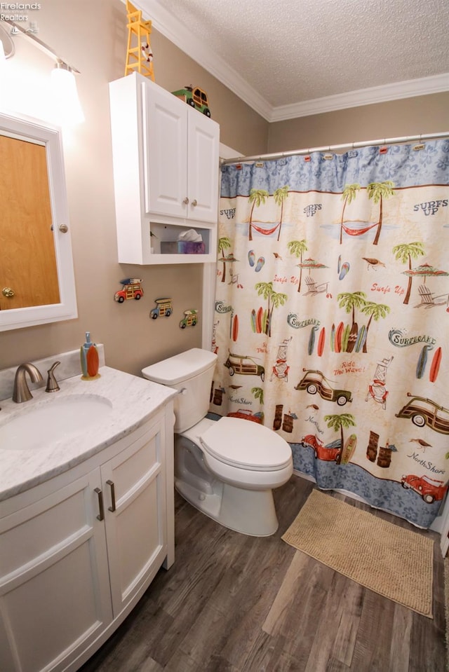 bathroom featuring a textured ceiling, wood finished floors, vanity, and crown molding