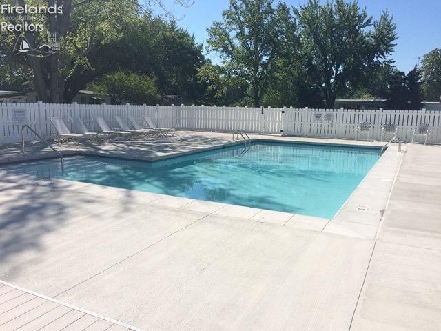 pool featuring fence and a patio