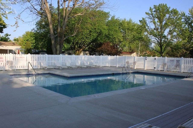 pool with fence and a patio