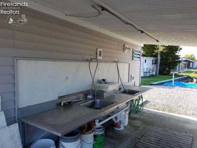 view of patio / terrace featuring a pool and a sink