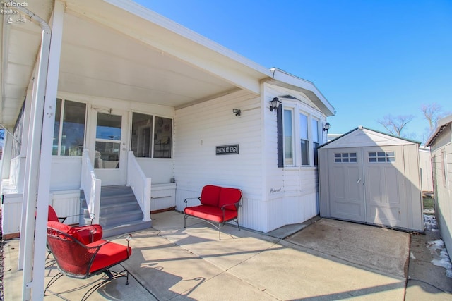 view of patio featuring entry steps, an outdoor structure, and a shed