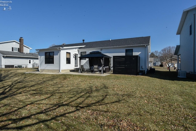 rear view of property featuring central AC, a gazebo, a patio, and a lawn