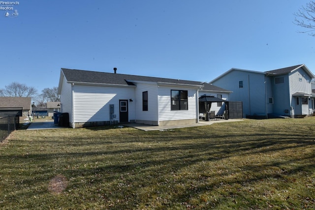 rear view of house featuring a gazebo, a lawn, a patio area, and fence