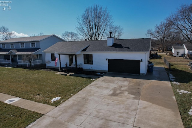 view of front of home featuring a garage, driveway, a chimney, and a front yard