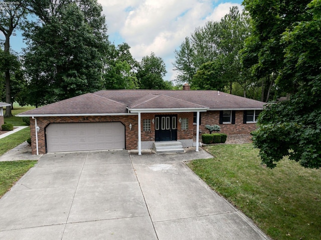 single story home featuring a front lawn, concrete driveway, brick siding, and an attached garage