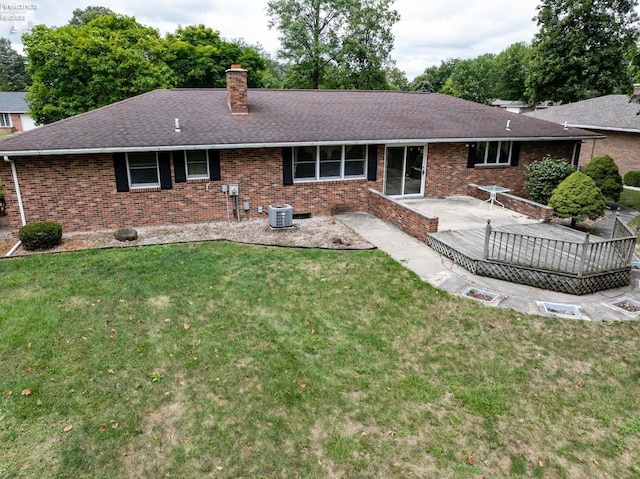 back of house with a yard, a patio, and brick siding