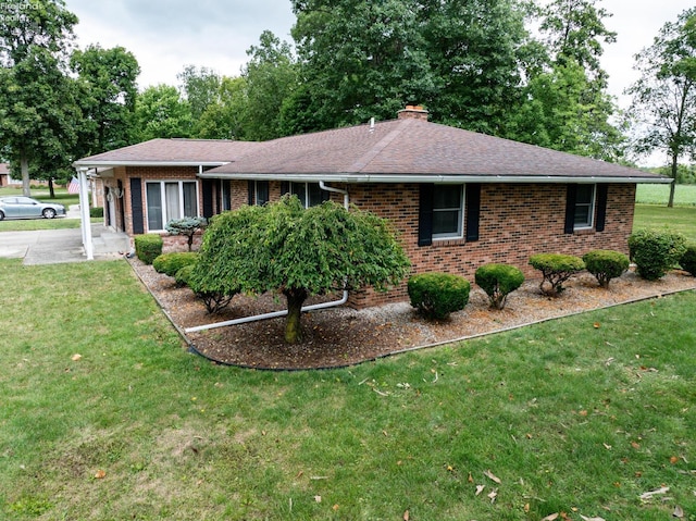 single story home with roof with shingles, a chimney, a front lawn, and brick siding