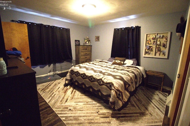 bedroom with wood finished floors