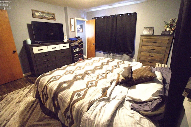 bedroom featuring dark wood-style flooring