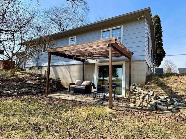 back of property featuring a pergola and a patio