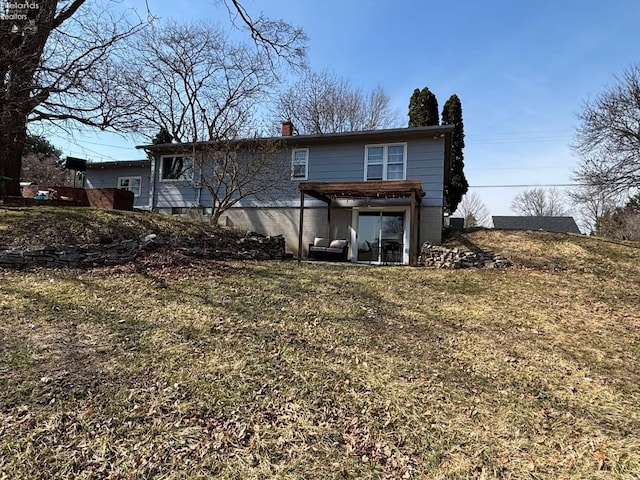 back of property with a lawn and a chimney