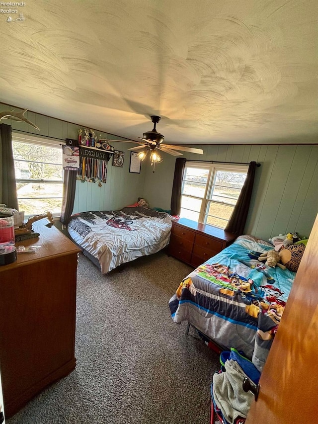 carpeted bedroom featuring a textured ceiling and ceiling fan