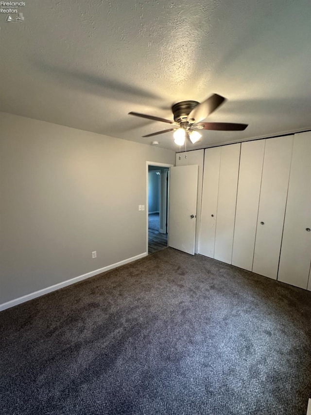 unfurnished bedroom featuring carpet floors, ceiling fan, and a textured ceiling